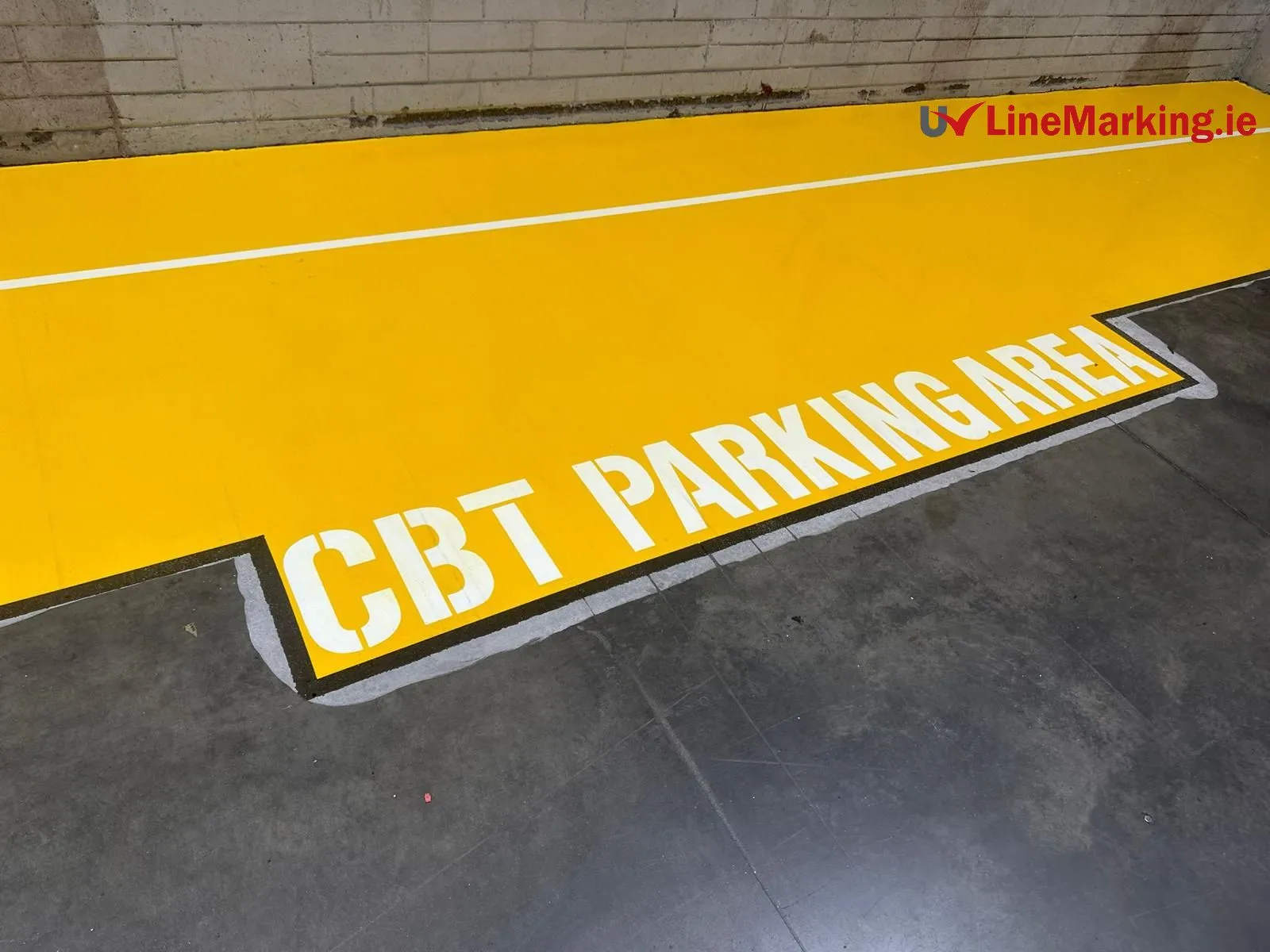 Yellow UV line marking defining a CBR parking area in a warehouse