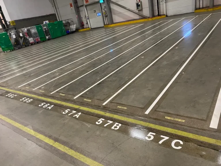 White warehouse floor line marking creating organised storage and loading bays