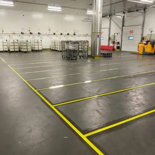 Yellow pallet grid floor markings in an industrial warehouse